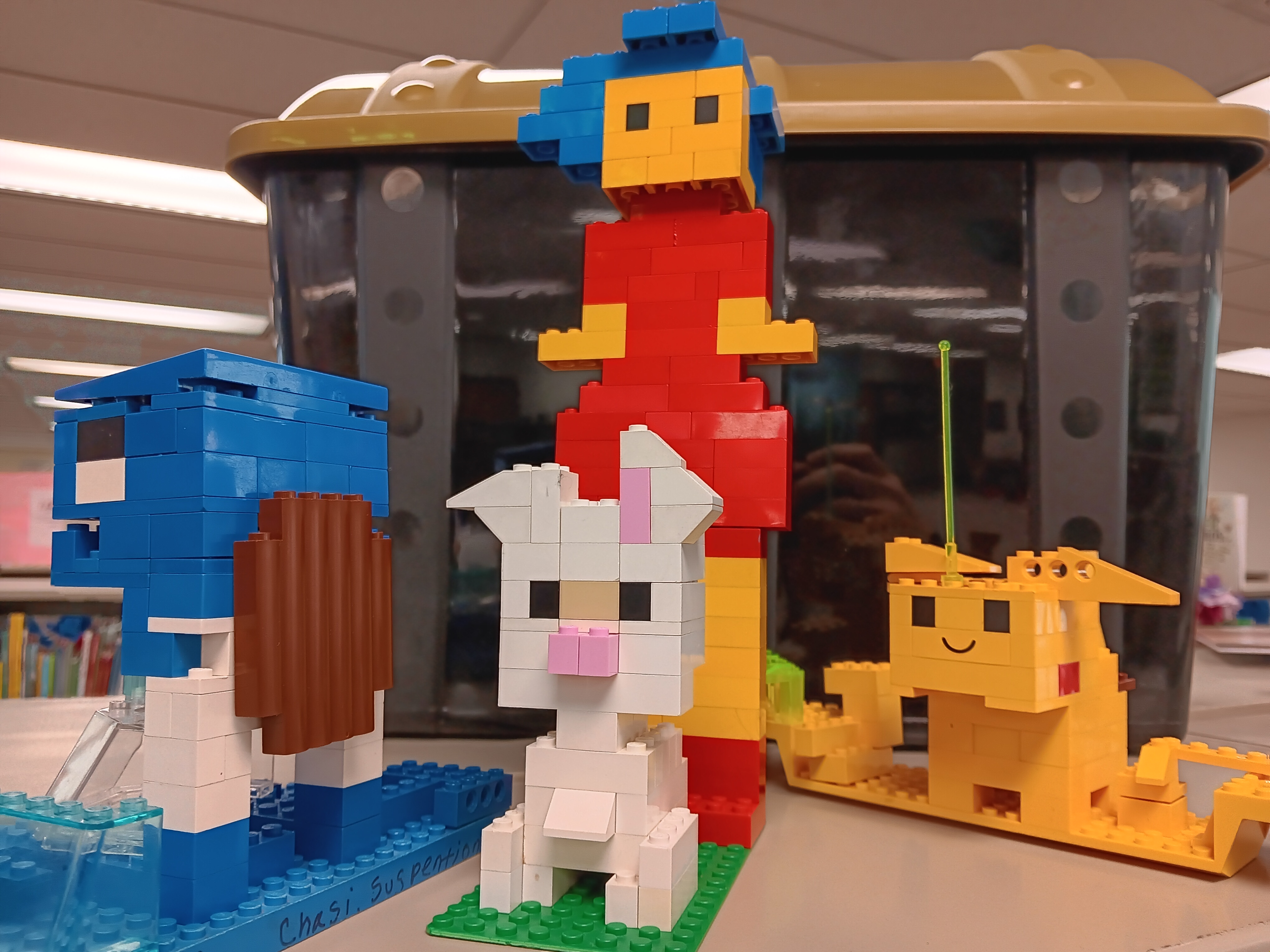 image of a girl, a bunny, and Pokemon Pikachu and Squirtle made of LEGOs, also serves as a link